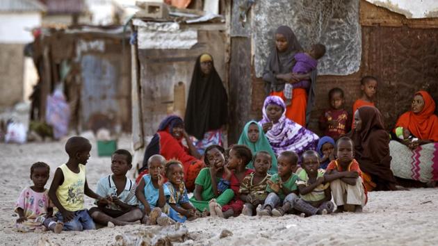 Somali women and children gather at dusk on a sandy street in the former pirate village of Eyl, in Somalia. Some of the former pirates had quit as the international pressure grew and armed guards appeared on cargo ships. They turned to fishing but now say they’re the ones being targeted at sea. (Ben Curtis/AP) Somali women and children gather at dusk on a sandy street in the former pirate village of Eyl, in Somalia. Some of the former pirates had quit as the international pressure grew and armed guards appeared on cargo ships. They turned to fishing but now say they’re the ones being targeted at sea. (Ben Curtis/AP)