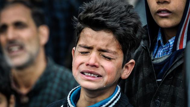 Nine-year-old Burhan Fayaz is seen crying at the funeral of his friend Amir Nazir, a civilian who was killed during an encounter in Pulwama last week. This photo, taken by HT photographer Waseem Andrabi, is being shared widely on social media.(Waseem Andrabi / HT Photo)