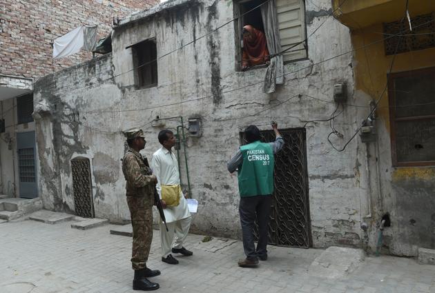 An official from the Pakistan Bureau of Statistics collects information from a resident as an army soldier stands guard in Lahore. Pakistan began its first census in almost two decades on Wednesday. (AFP) An official from the Pakistan Bureau of Statistics collects information from a resident as an army soldier stands guard in Lahore. Pakistan began its first census in almost two decades on Wednesday. (AFP)