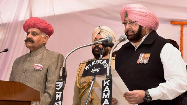 Captain Amarinder Singh taking the oath of office as the new Punjab chief minister, at the Raj Bhavan in Chandigarh on Thursday. (PTI) Captain Amarinder Singh taking the oath of office as the new Punjab chief minister, at the Raj Bhavan in Chandigarh on Thursday. (PTI)