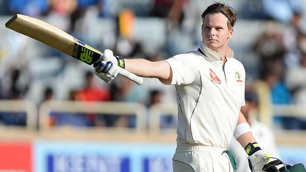 Australia's captain Steve Smith raises his bat while celebrating his century. (AFP)
