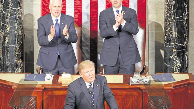 US President Donald Trump addresses a joint session of the US Congress as Mike Pence (left) and House Speaker Paul Ryan look on.(AFP File Photo)