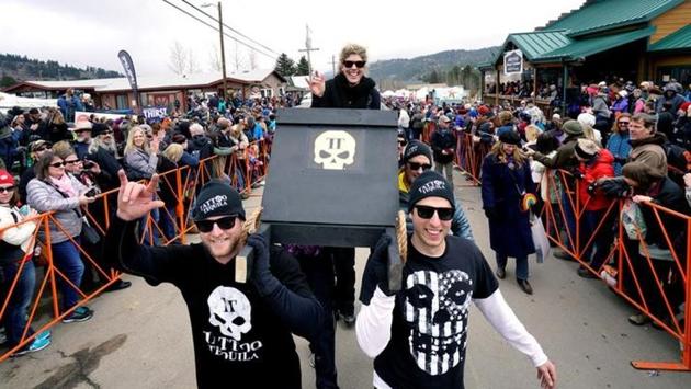 The Tattoo Tequila coffin race team parades down the street in Nederland. The Tattoo Tequila coffin race team parades down the street in Nederland.