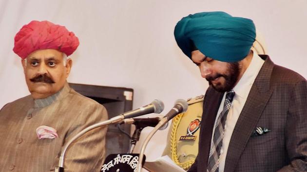 Punjab Governor V P Singh Badnore administering oath to the new Punjab cabinet Minister Navjot Singh Sidhu at the Raj Bhavan in Chandigarh. (PTI) 