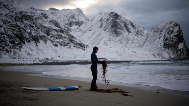 A novice surfer cleans his leash as he prepares for surfing. (Olivier Morin/AFP) A novice surfer cleans his leash as he prepares for surfing. (Olivier Morin/AFP)