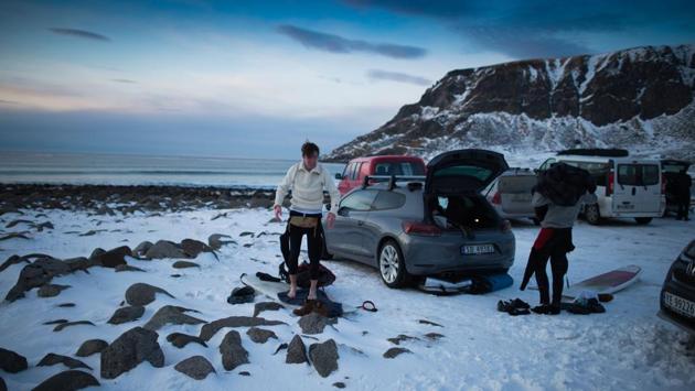 Surfers take off their wet kit after enjoying the waves. (Olivier Morin/AFP) Surfers take off their wet kit after enjoying the waves. (Olivier Morin/AFP)