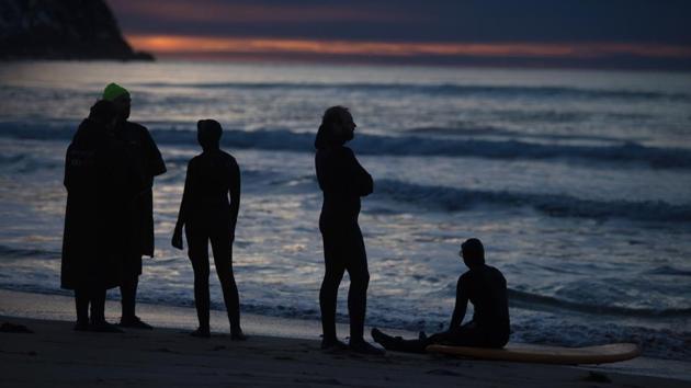 Surfers rest and enjoy the beautiful unset after surfing along the northern Atlantic Ocean. (Olivier Morin/AFP) Surfers rest and enjoy the beautiful unset after surfing along the northern Atlantic Ocean. (Olivier Morin/AFP)