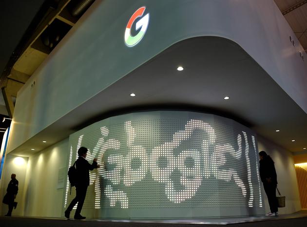 Two people visit the stand of Google on the second day of the Mobile World Congress on February 28, 2017 in Barcelona. (AFP)