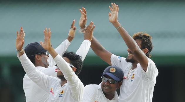 Sri Lanka cricket team's Suranga Lakmal celebrates with skipper Rangana Herath (second right) and other team mates after taking the wicket of Bangladesh national cricket team’s Sabbir Rahman in Colombo on Thursday.(AP)