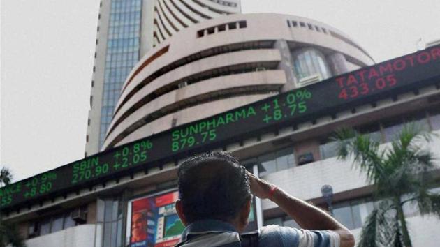 A man watches share price movement outside BSE, Mumbai (PTI photo) A man watches share price movement outside BSE, Mumbai (PTI photo)
