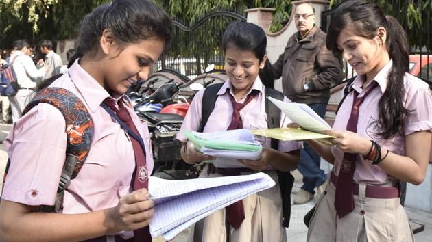 Students outside examination centre before writing their CBSE Class 12 board exam at Evergreen School, Vasundhra Enclave on Thursday.(Mohd Zakir/HT Photo)