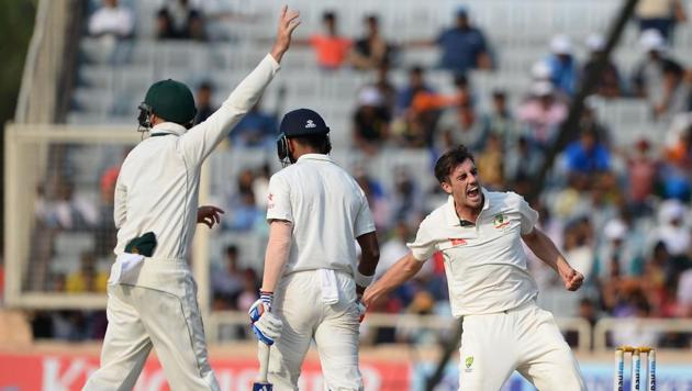 Australian bowler Pat Cummins (R) celebrates after he dismissing India's KL Rahul. (AFP)