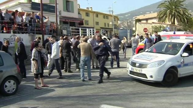 In this image from TV, Police cordon off the area as people gather to view the nearby high school, following a shooting in Grasse, southern France, Thursday March 16, 2017.(AP Photo)