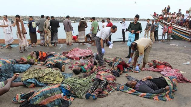 Police officers check the bodies of Somali refugees, killed in attack by a helicopter while travelling in a vessel off Yemen, at the Red Sea port of Hodeidah. (REUTERS) Police officers check the bodies of Somali refugees, killed in attack by a helicopter while travelling in a vessel off Yemen, at the Red Sea port of Hodeidah. (REUTERS)