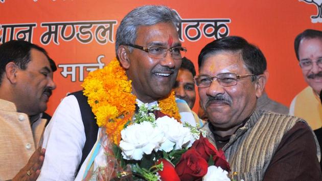 State BJP president Ajay Bhatt presents a bouquet to Trivendra Singh Rawat after the latter was nominated as the new chief minister of Uttarakhand, in Dehradun on Friday. (Vinay Santosh Kumar/HT Photo) State BJP president Ajay Bhatt presents a bouquet to Trivendra Singh Rawat after the latter was nominated as the new chief minister of Uttarakhand, in Dehradun on Friday. (Vinay Santosh Kumar/HT Photo)