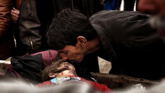 Relatives mourn over the body on an Iraqi child, killed in an airstrike targetting Islamic State (IS) group jihadists, West Mosul. According to a Unicef report, with at least 652 children killed in 2016 – a 20% increase on the year before – and 850 children recruited to fight in the conflict, nearly three times the 331 enlisted in 2015. (ARIS MESSINIS / AFP)