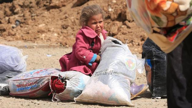 A displaced Iraqi girl who fled from Islamic State militants cries as Iraqi forces battle with the militants in the Mansour district of Mosul. The conflict has taken a devastating toll on the mental health of Syria’s children. (Ari Jalal / REUTERS)