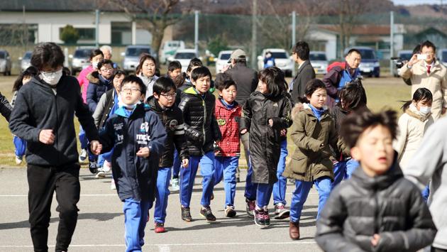 Elementary school students and others take shelter during an evacuation drill in Oga on Friday. (AP) Elementary school students and others take shelter during an evacuation drill in Oga on Friday. (AP)