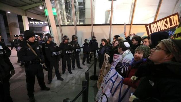Protesters gather outside Terminal 4 at JFK airport in opposition to US president Donald Trump's proposed ban on immigration in Queens, New York City. Protesters gather outside Terminal 4 at JFK airport in opposition to US president Donald Trump's proposed ban on immigration in Queens, New York City.