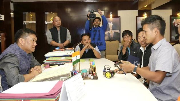 Anang Tadar (right), a class 11 student, explains how his innovation, the Goggles for Blind works, to Arunachal Pradesh chief minister Pema Khandu at Itanagar on Friday.(HT PHOTO) Anang Tadar (right), a class 11 student, explains how his innovation, the Goggles for Blind works, to Arunachal Pradesh chief minister Pema Khandu at Itanagar on Friday.(HT PHOTO)
