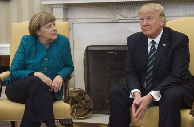 US President Donald Trump and German Chancellor Angela Merkel meet in the Oval Office of the White House in Washington, DC, on Friday. (AFP)