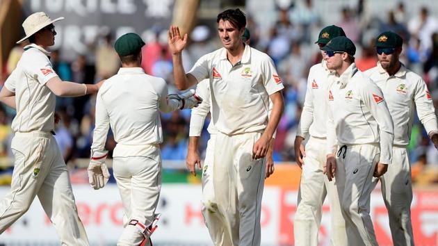 Australian bowler Pat Cummins (C) celebrates with teammates after he dismissing Indian batsman Ravichandran Ashwin. (AFP) 