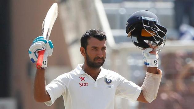Cheteshwar Pujara of India celebrates after scoring his century. 