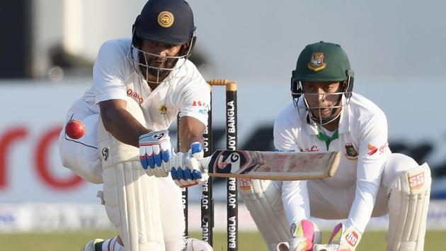 Dimuth Karunaratne fell for 126, his fifth Test century as Sri Lanka ended day 4 on 268/8, a lead of 139 runs against Bangladesh. Get full cricket score of Sri Lanka vs Bangladesh here.(AFP)