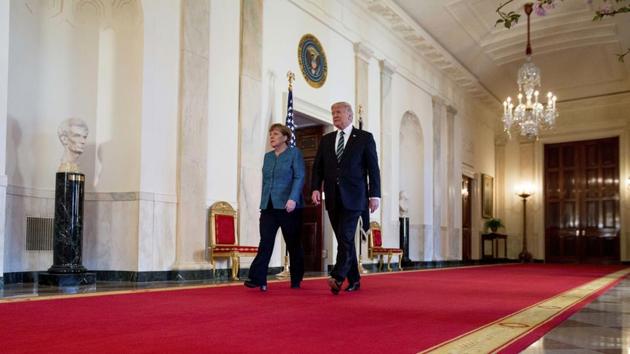 President Donald Trump and German Chancellor Angela Merkel arrive for a joint news conference in the East Room of the White House in Washington, Friday.(AP Photo)