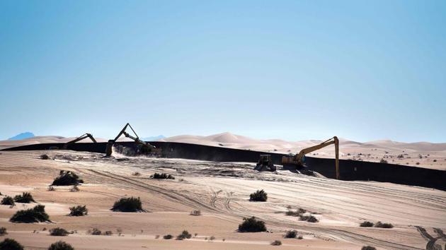 Photo taken on February 15, 2017 shows a construction crew working near the border fence on the US/Mexico border at the Imperial Sand Dunes in Dunes, California.(AFP File Photo) Photo taken on February 15, 2017 shows a construction crew working near the border fence on the US/Mexico border at the Imperial Sand Dunes in Dunes, California.(AFP File Photo)
