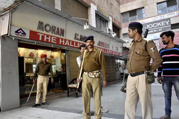 Policemen guard outside a jewellery shop during an IT raid in Patna on Wednesday. PTI Photo(PTI2_22_2017_000040B) (PTI) Policemen guard outside a jewellery shop during an IT raid in Patna on Wednesday. PTI Photo(PTI2_22_2017_000040B) (PTI)