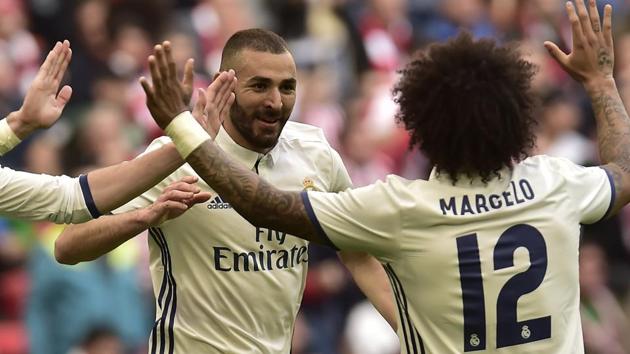 Real Madrid C.F.'s Karim Benzema celebrates with Marcelo Vieira (right) after scoring against Athletic Bilbao in La Liga on Saturday (AP) Real Madrid C.F.'s Karim Benzema celebrates with Marcelo Vieira (right) after scoring against Athletic Bilbao in La Liga on Saturday (AP)