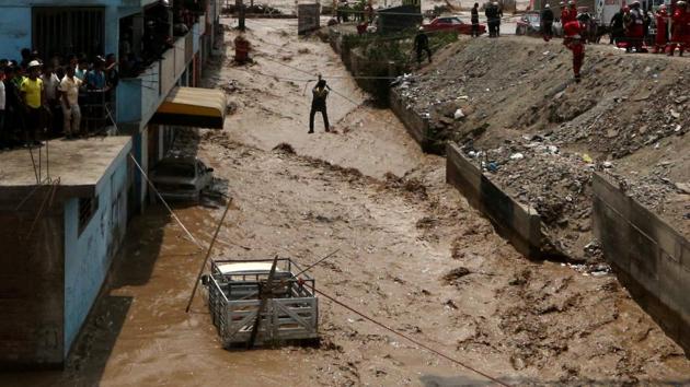 A man gets rescued after a massive landslide and flood in the Huachipa district of Lima, Peru. (Guadalupe Pardo / REUTERS) 