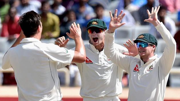 Pat Cummins (L) celebrate with his teammates after dismissing Indian skipper Virat Kohli. (PTI) 