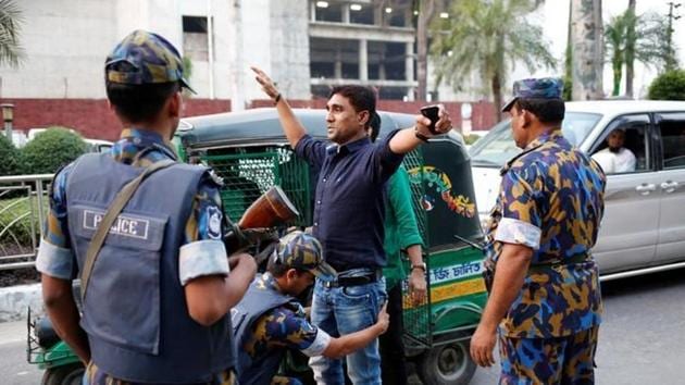 Security personnel check a man near the Hazrat Shahjalal International Airport as Bangladesh government proclaimed red alert in all airports and prisons across the country after an unidentified suicide bomber died inside a makeshift camp of Rapid Action Battalion (RAB) in Dhaka on March 17. (Reuters Photo) Security personnel check a man near the Hazrat Shahjalal International Airport as Bangladesh government proclaimed red alert in all airports and prisons across the country after an unidentified suicide bomber died inside a makeshift camp of Rapid Action Battalion (RAB) in Dhaka on March 17. (Reuters Photo)