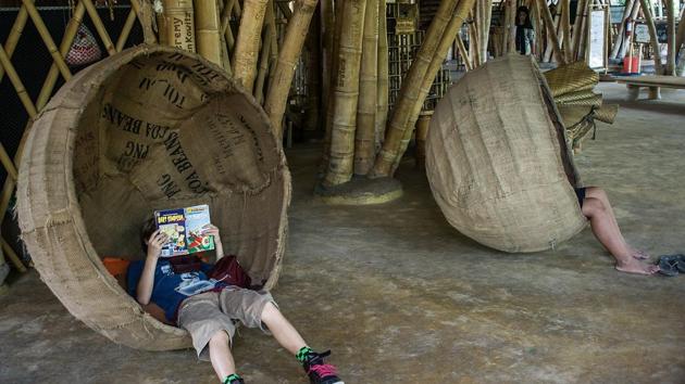 Reading from cover to cover: Children immersed in their books at Green School in Badung, Bali, Indonesia.(Getty Images)
