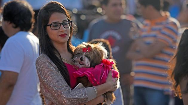 Close for comfort: A woman at the event with her dog. (Pratik Chorge/HT PHOTO)