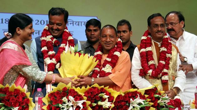 Union minister M Venkaiah Naidu (R), Uttar Pradesh BJP leaders Prasad Maurya (2L) and Dinesh Sharma (2R) look on as Yogi Adityanath (C) is presented with a floral bouquet during a ceremony in Lucknow on March 18, after he was picked as the new chief minister.(AFP Photo)