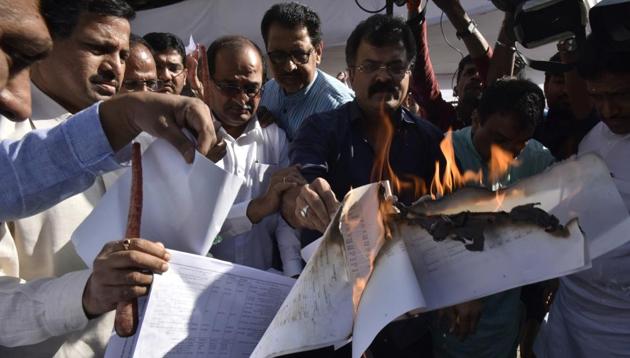 NCP MLA Jitendra Awhad, other members of the Opposition, burn copies of the state budget at Vidhan Bhawan in Mumbai.(Anshuman Poyrekar/HT Photo)