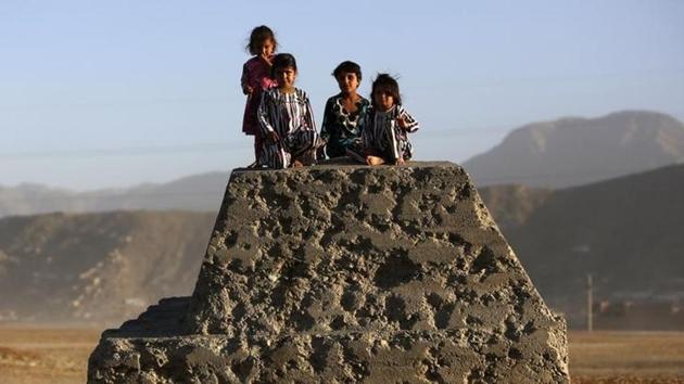 Afghan children sit on a bullet-riddled concrete block in Kabul on October 21, 2013. (Reuters File) Afghan children sit on a bullet-riddled concrete block in Kabul on October 21, 2013. (Reuters File)
