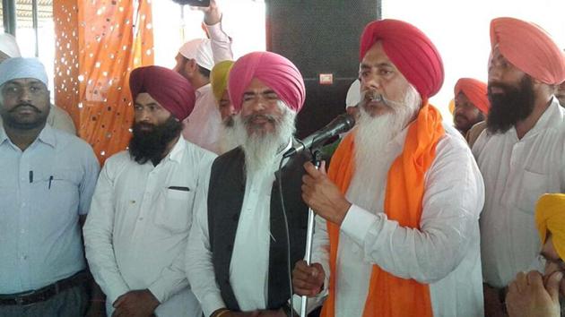 Congress MLA Harminder Singh Gill addressing a public meeting at a village in the Patti assembly segment in Tarn Taran on Sunday.(HT Photo)