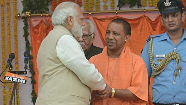 Prime Minister Narendra Modi greets Yogi Adityanath, who was sworn in as the Uttar Pradesh chief minister in Lucknow on Sunday.(Ashok Dutta/HT Photo) Prime Minister Narendra Modi greets Yogi Adityanath, who was sworn in as the Uttar Pradesh chief minister in Lucknow on Sunday.(Ashok Dutta/HT Photo)