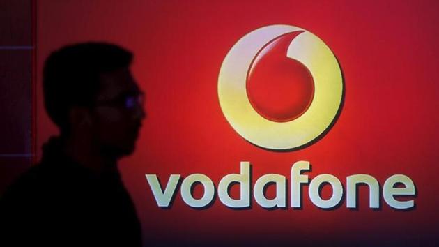 A man casts silhouette onto an electronic screen displaying logo of Vodafone India. The British telecom group has decided to merge its Indian subsidiary with local rival Idea Cellular. (Reuters) A man casts silhouette onto an electronic screen displaying logo of Vodafone India. The British telecom group has decided to merge its Indian subsidiary with local rival Idea Cellular. (Reuters)