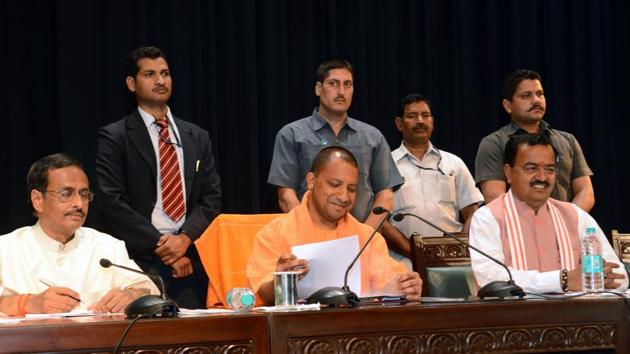 Uttar Pradesh chief minister Adityanath flanked by his deputies Keshav Prasad Maurya and Dinesh Sharma during his first high-level meeting with administrative officers at Lok Bhavan in Lucknow on Monday. (Ashok Dutta/ HT Photo) Uttar Pradesh chief minister Adityanath flanked by his deputies Keshav Prasad Maurya and Dinesh Sharma during his first high-level meeting with administrative officers at Lok Bhavan in Lucknow on Monday. (Ashok Dutta/ HT Photo)