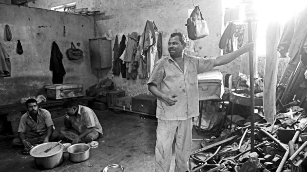 Many trackmen live so far away from their worksites that going home every day is not an option. So they live in makeshift shelters called tapris. This is the inside of a tapri near Platform 6 of CST. The men take turns to do the cooking. “I’ve made a 3 kg handi of pulao today,” says Vijay Harpal (standing). “We eat like tigers.”  (Pratik Chorge/HT PHOTO) 