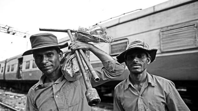 It’s endless, exhausting work. You have to carry your own tools on your back as you trudge for miles, in the heat of summer or in pouring rain. Here, Rahul Kumar and a fellow gangman head back to CST after eight hours on their feet. (Pratik Chorge/HT PHOTO) 