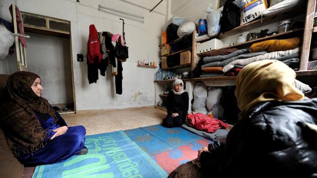 Un Ghazi (C), mother of cancer patient Ghazi, rests near other women inside a shelter provided by Basma. President Bashar al-Assad has partly blamed the sanctions for turning many Syrians into refugees, often heading to Europe. (Omar Sanadiki/REUTERS) Un Ghazi (C), mother of cancer patient Ghazi, rests near other women inside a shelter provided by Basma. President Bashar al-Assad has partly blamed the sanctions for turning many Syrians into refugees, often heading to Europe. (Omar Sanadiki/REUTERS)