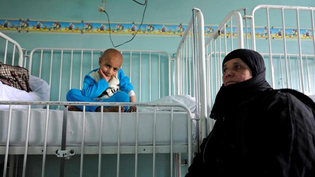 Syrian girl Rahma (L) sits on a bed next to her grandmother Um Ahmad, as she receives treatment for cancer. On top of this, cuts in health spending by the government that is fighting a hugely expensive war, a drastic fall in the Syrian currency and indirect effects of the sanctions are all deepening the misery of patients who need foreign-made drugs. (Omar Sanadiki/REUTERS) Syrian girl Rahma (L) sits on a bed next to her grandmother Um Ahmad, as she receives treatment for cancer. On top of this, cuts in health spending by the government that is fighting a hugely expensive war, a drastic fall in the Syrian currency and indirect effects of the sanctions are all deepening the misery of patients who need foreign-made drugs. (Omar Sanadiki/REUTERS)