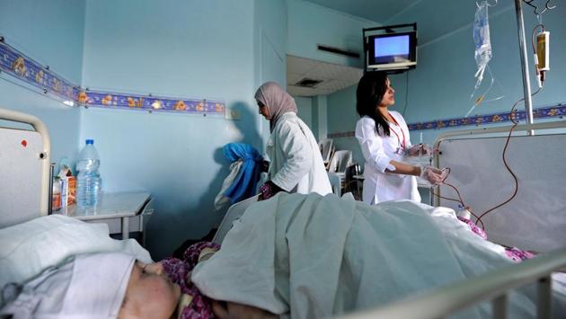 Nurses tend to a child with cancer at Damascus Children's Hospital. At the children’s hospital in government-held Damascus, the waiting room outside the cancer ward was crowded with relatives, many of whom had brought clothes, mattresses and blankets in case they had to spend long periods far from their homes outside the city. (Omar Sanadiki/REUTERS) Nurses tend to a child with cancer at Damascus Children's Hospital. At the children’s hospital in government-held Damascus, the waiting room outside the cancer ward was crowded with relatives, many of whom had brought clothes, mattresses and blankets in case they had to spend long periods far from their homes outside the city. (Omar Sanadiki/REUTERS)