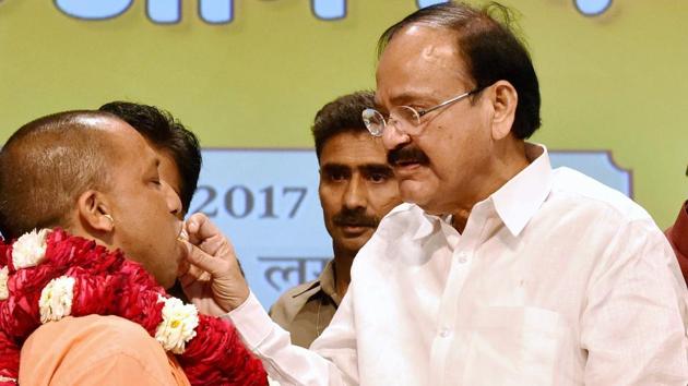 Union minister M Venkaiah Naidu offers sweets to Yogi Adityanath, the new chief minister of Uttar Pradesh. (PTI) Union minister M Venkaiah Naidu offers sweets to Yogi Adityanath, the new chief minister of Uttar Pradesh. (PTI)